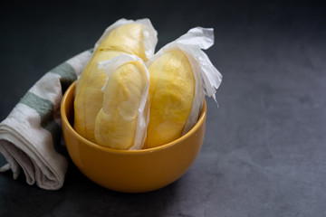 Tasty durian that has been peeled in yellow bowl