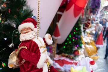 Santa Claus climbing up the ladder concept. Close-up.