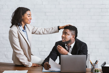 Workplace molestation. Handsome African American guy sexually harassed by his female coworker in...