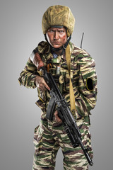 Fototapeta premium Male in uniform conforms to Russian army special forces (OMON)&nbsp;in War in Chechnya. Isolated on grey background