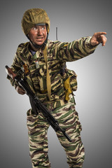 Male in uniform conforms to Russian army special forces (OMON) in War in Chechnya. Isolated on grey background