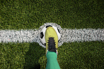 Top view of a soccer player standing on the center of soccer fieldfield