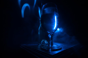 Goblet of white wine on wooden table on wooden wall background