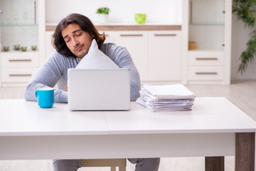 Young male employee freelancer working from home