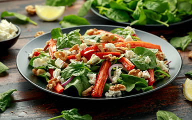Roasted carrot salad with feta cheese, walnut and spinach. healthy food