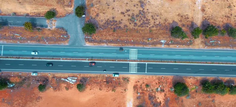 chennai,India; A road with vehicles and a dramatic rotating aerial shot.