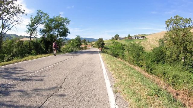 a pilgrim walking a country road next to Sivizzano village, municipality of Fornovo di Taro, province of Parma, Emilia-Romagna region, Italy