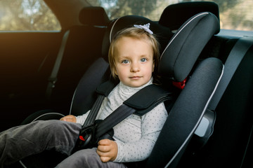 Transport, safety, childhood road trip and people concept. Happy Caucasian cute little baby girl...