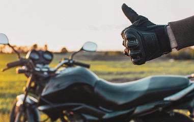 man shows his hand ok and holds his finger up on the background of motorcycles