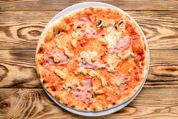 Delicious italian pizza served on wooden table