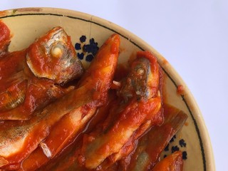 Donzella fishes cooked with tomato sauce