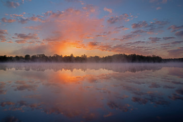 Landscape of a spring sunrise, Whitford Lake in light fog, Fort Custer State Park, Michigan, USA