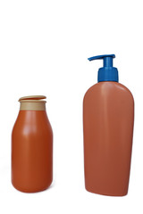 Two orange bottles of different sizes for liquid cosmetic products, such as soap, shower gel, shampoo.