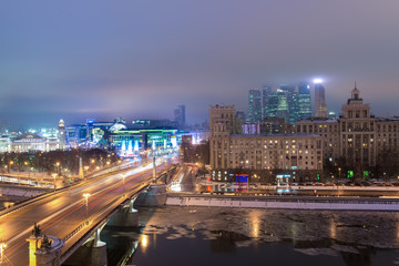 MOSCOW, RUSSIA - 4 JANUARY 2017: Night view to Borodinsky Bridge over the Moskva river, Evropeisky shopping mall and Moscow City international business center on background