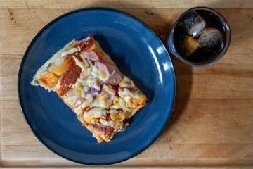 Ham, Onion and pepperoni pizza with a glass of cola