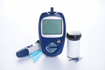 Diabetes. Electronic glucometer, lancet and test strip for determining blood sugar levels isolated...