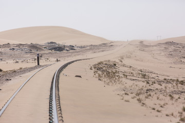Abandoned and forgotten railway being taken over by encroaching sandstorm, Kolmanskop ghost town, Namib Desert. Africa