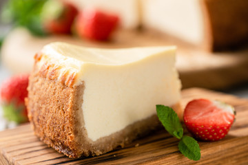 New York Style Cheesecake With Strawberries On Wooden Background Closeup View