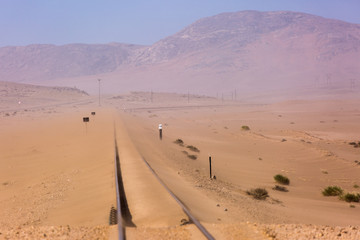 Abandoned and forgotten railway being taken over by encroaching sandstorm, Kolmanskop ghost town,...