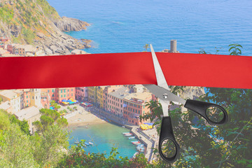 Sale of airline tickets. Scissors cut the red ribbon overlooking the picturesque village of Vernazza, Italy