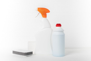 House cleaning. Sponges and cleaning agent for plumbing, sinks, bathtubs, toilet bowls in bottles on a white background