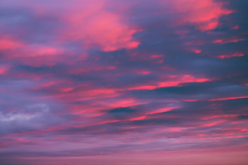 Obraz premium Dreamy romantic sky with clouds at sunset in pink-blue colors