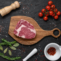 Flat lay composition with fresh beef cut on wooden table