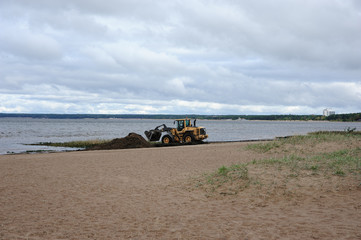 tractor cleaning the beach. Gulf of Finland, St. Petersburg