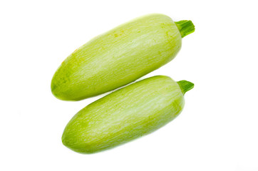 Young light green zucchini, organic natural on a white background. Zucchini sideways, on top. Two zucchini, zucchini  tails