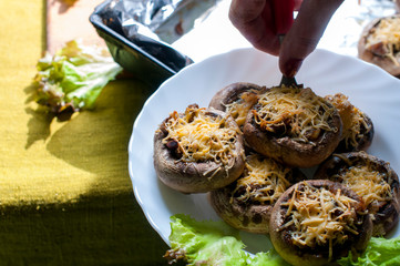 mushrooms with grated cheese before baking in the oven