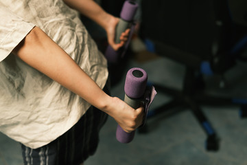 Unrecognized woman workout at home with Dumbbells medium closeup shot