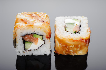 Rolls with sea eel close-up on a mirror surface.