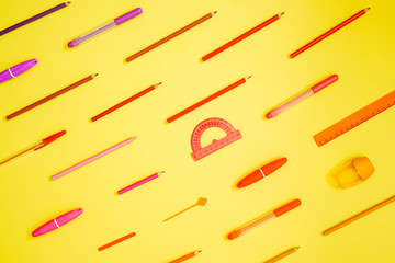 Stationery on yellow. Flat lay. Rows of tools, gradient colors.
