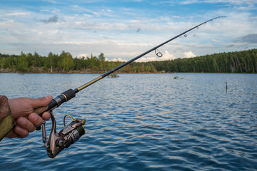 Fishing. The spinning rod in the arm.