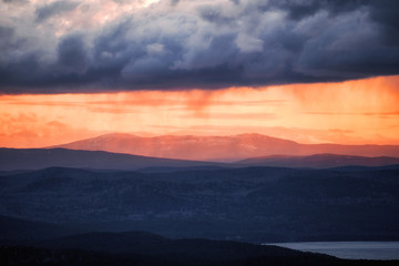 Orange Sun Setting Behind the Mountains