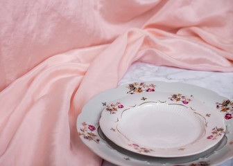 vintage plates on a pink silk