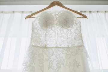 white bride's dress. Detail of the dress close-up. The dress on a hanger.