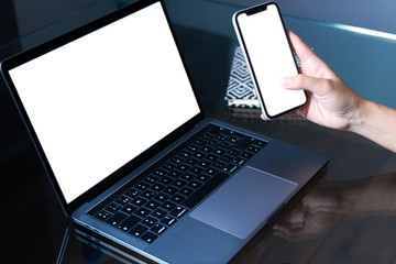 Woman working with phone and laptop. Student using modern technologies. Freelancer.  Closeup Laptop and phone.