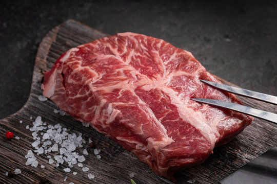 Top blade beef shoulder steak on a wooden chopping Board
