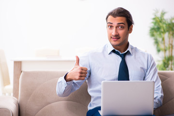 Young male employee working from house