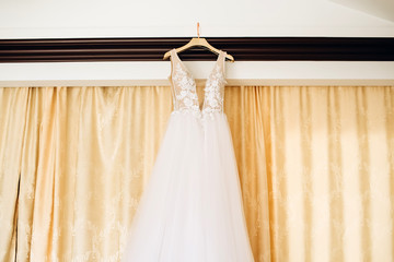 white bride's dress. Detail of the dress close-up. The dress on a hanger.