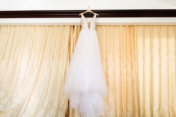 white bride's dress. Detail of the dress close-up. The dress on a hanger.
