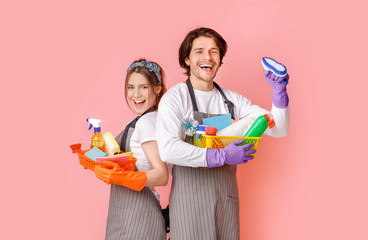 Portrait Of Positive Professional Cleaners Team With Household Supplies In Hands