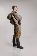Actor man in an old military uniform and camouflage clothing of a soldier of the Soviet army during...