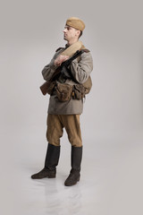 Actor man in an old military uniform and camouflage clothing of a soldier of the Soviet army during...
