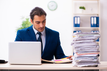 Young male employee unhappy with excessive work