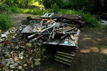 Fototapeta na wymiar Wild discharge. Debris and rubbish. Heaps of scrap metal, and steel thrown into the wild. Household garbage abandoned in the wild. Environmental problem concept with pollution.