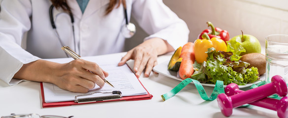 Nutritionist giving consultation to patient with healthy fruit and vegetable, Right nutrition and...