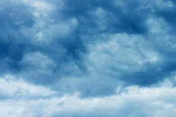 Blue sky with storm clouds. Concept bad cold weather, climate change, thinning of the ozone layer, acid rain.