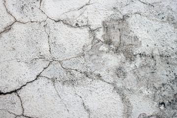 The texture of an old white cracked stucco wall. Texture for design, material for 3D modeling.